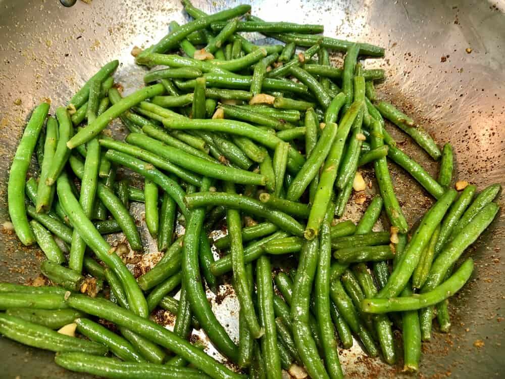 Green beans sauteeing in a pan