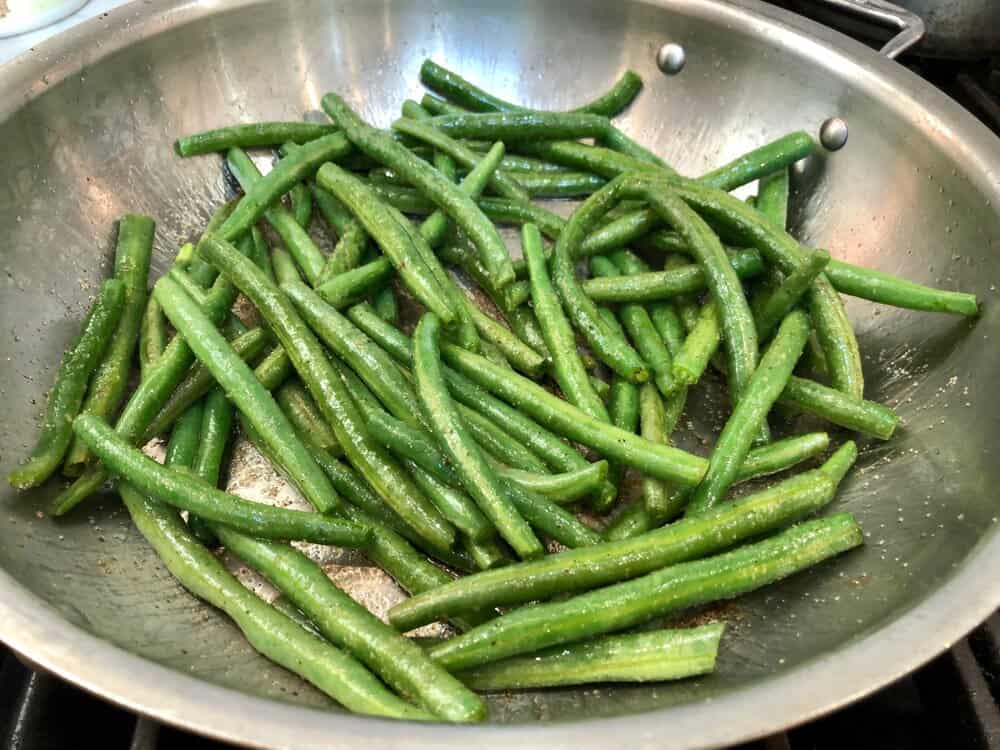 Green beans sauteeing in a pan