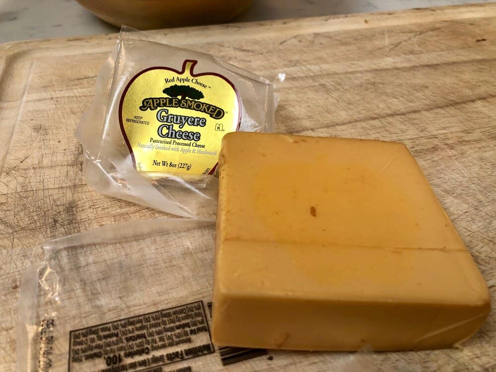 Apple smoked gruyere cheese on a cutting board