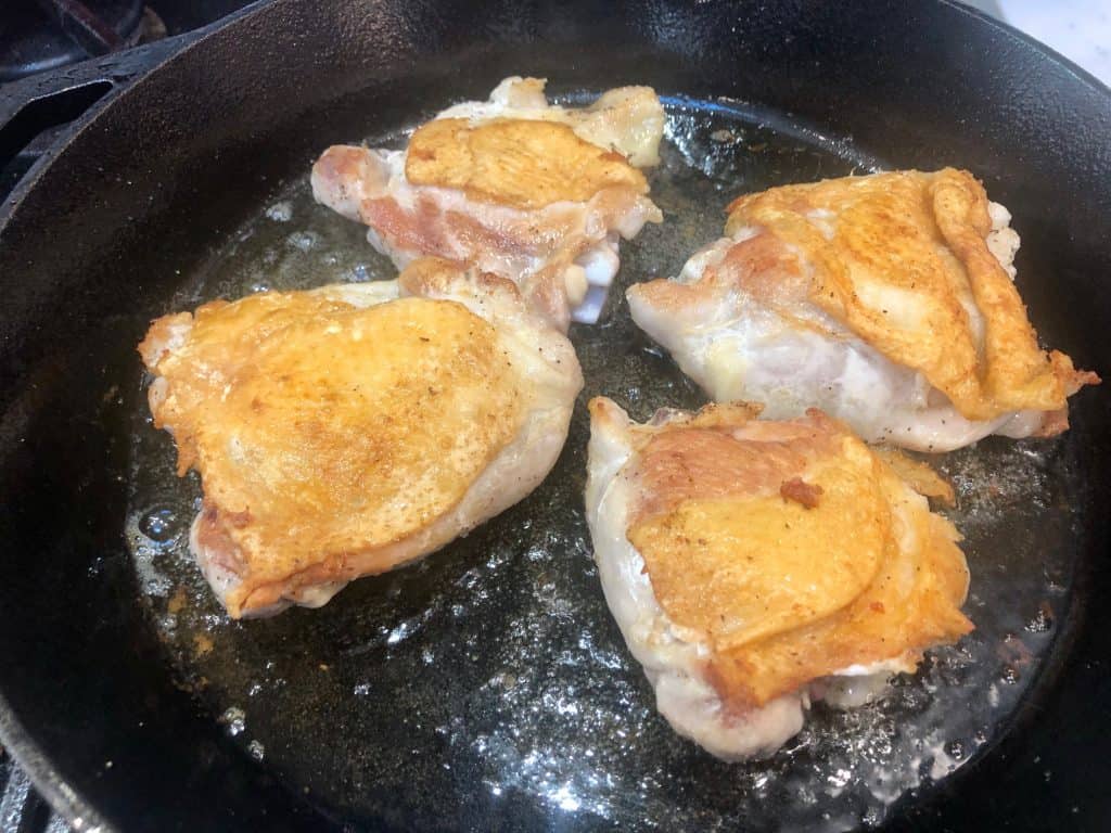 Pan searing chicken in a skillet