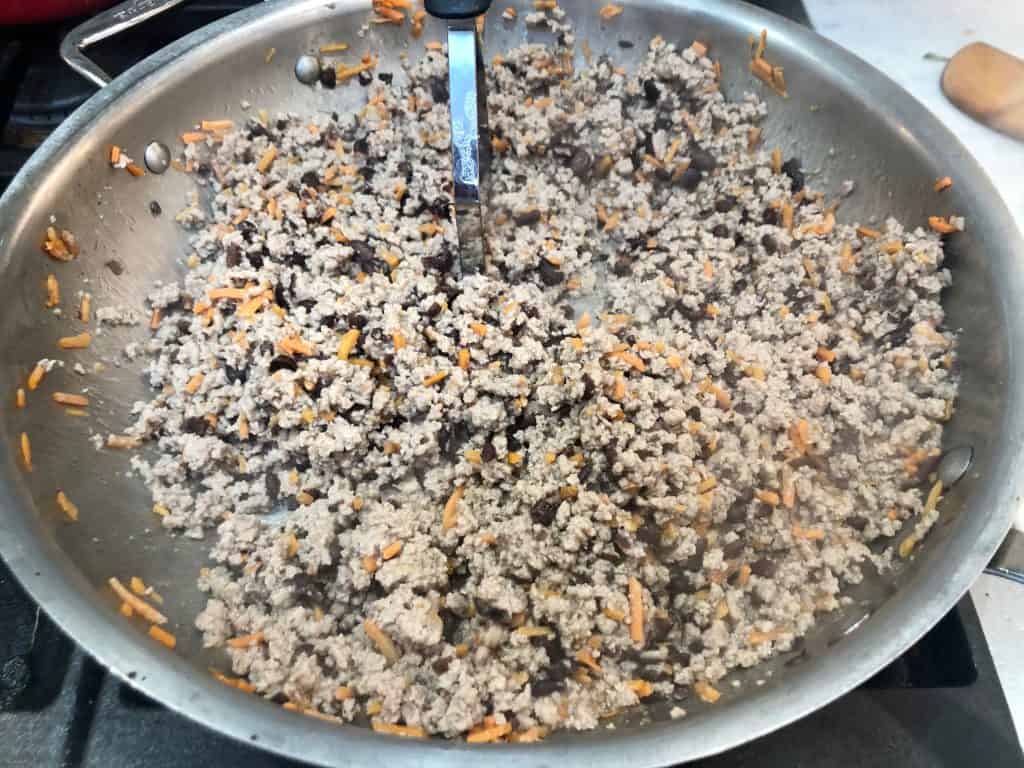 Ground turkey, beans, and carrots cooking in a pan