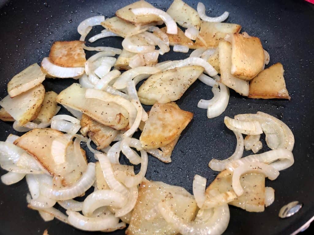 Cooked potatoes and onions in a pan