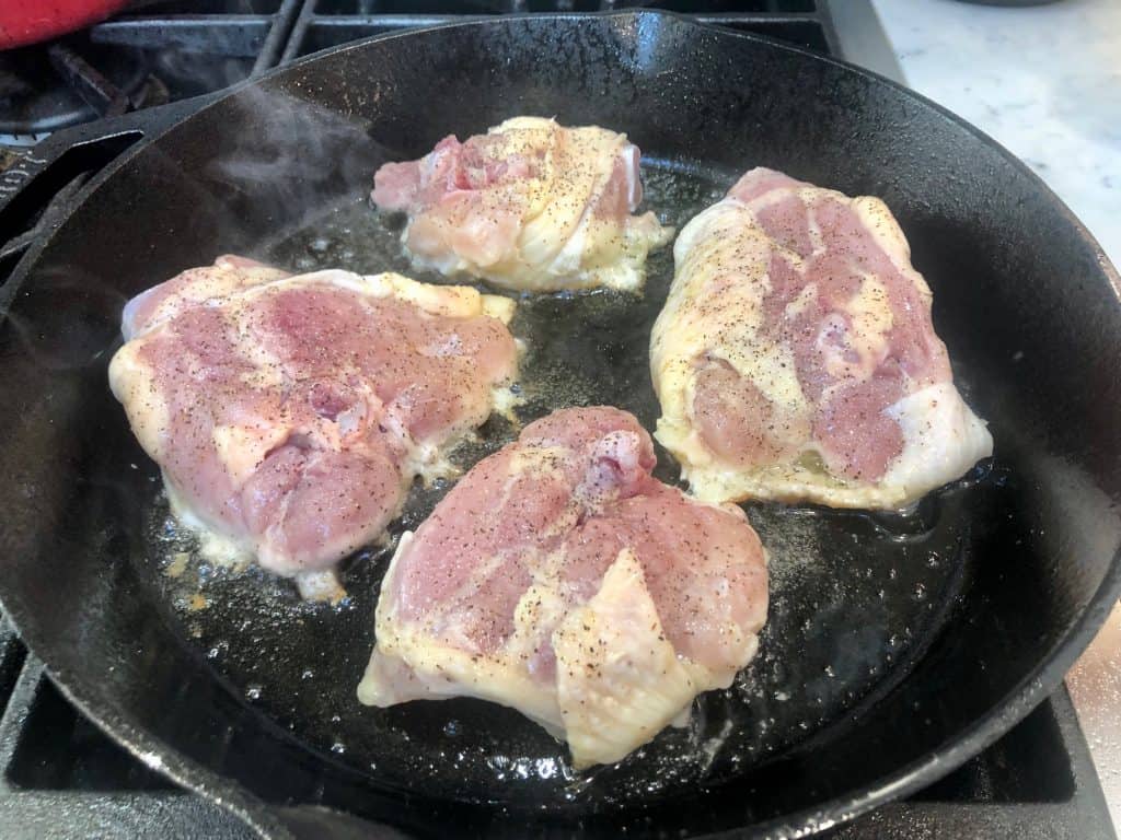 Chicken frying in a skillet