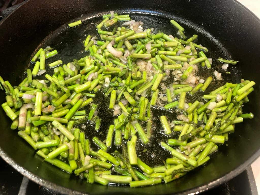 Asparagus and shallot cooking in a pan