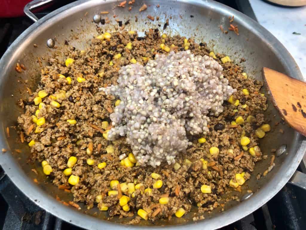 Cooked buckwheat added to seasoned meat