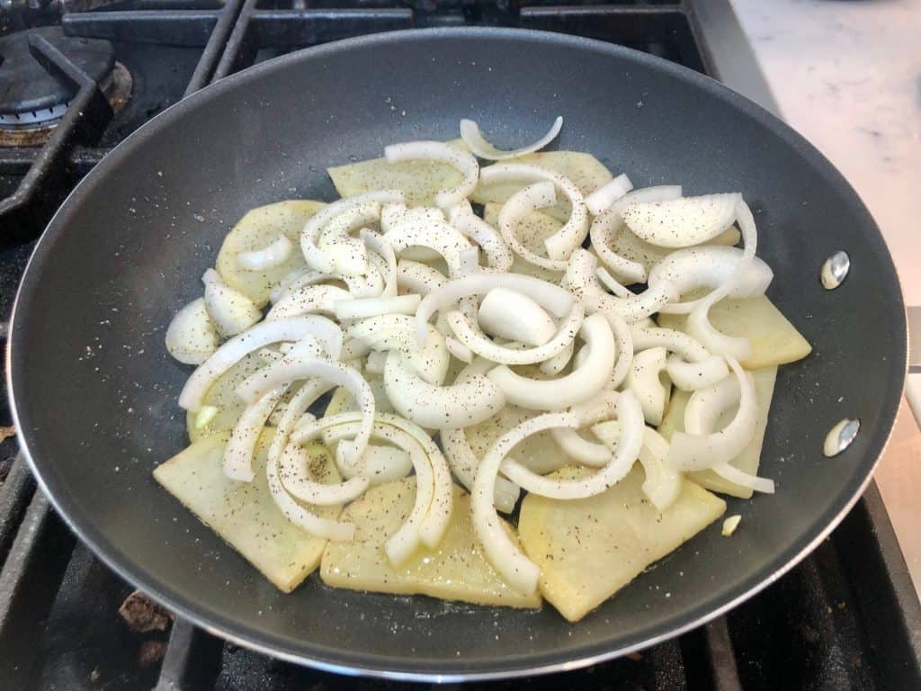 Potatoes and onions frying in a pan