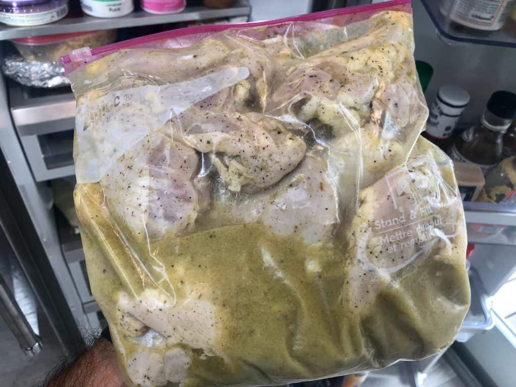 Chicken marinating in a ziploc