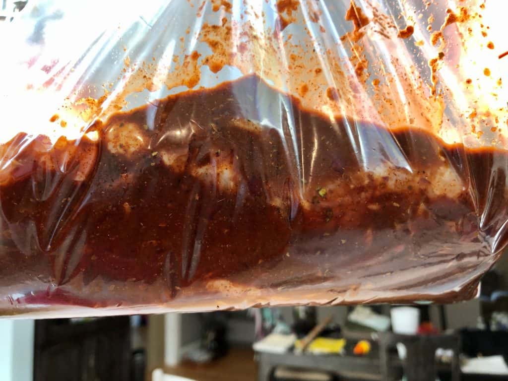 Chicken marinating in a bag