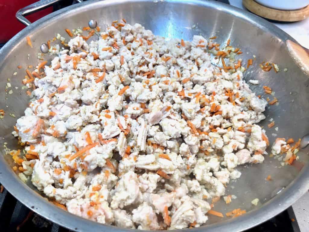 Cooked ground turkey with vegetables in a pan
