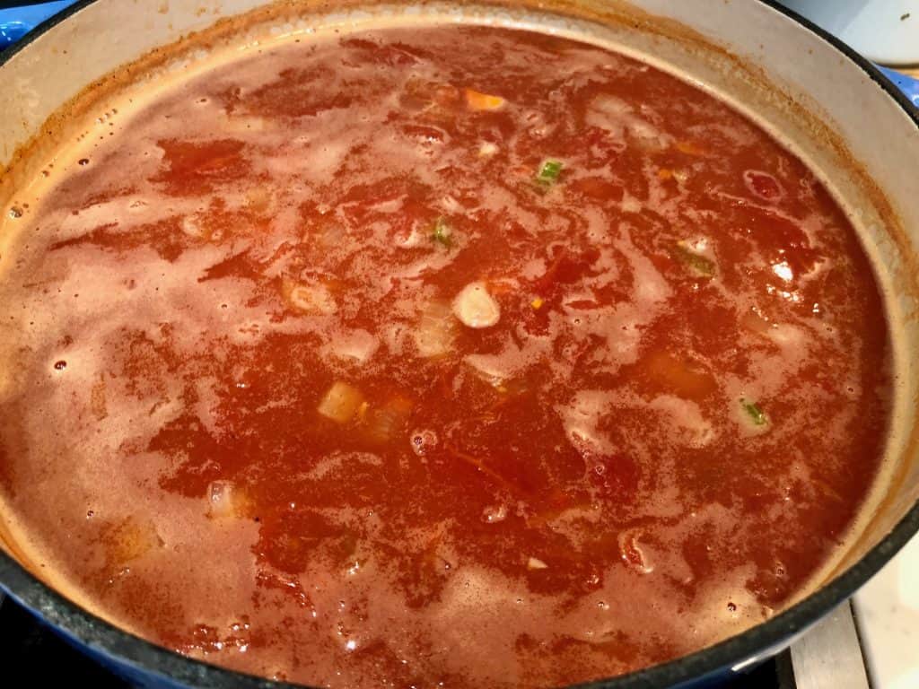 Tomatoes, beans and chicken broth cooking