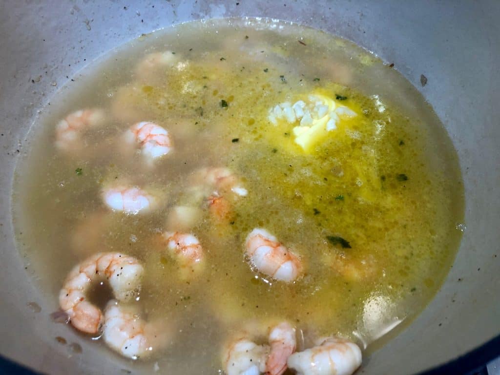 Chicken broth added to cooked shrimp