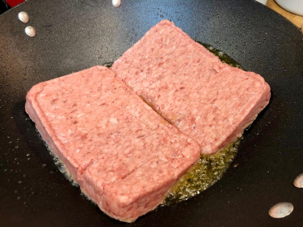 Ground pork cooking in a wok