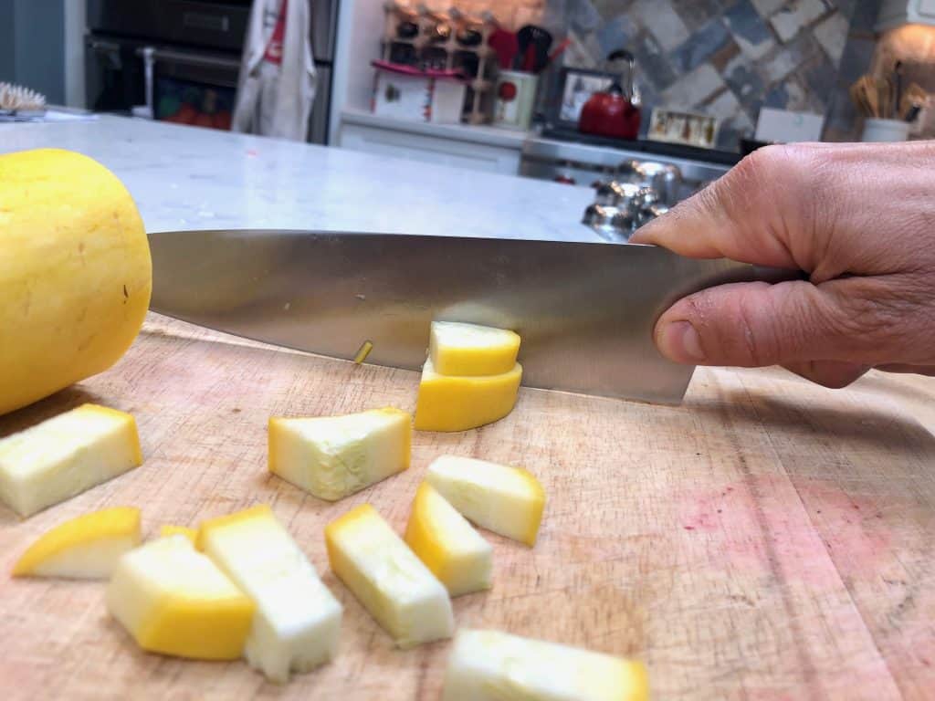 Misen chef's knife cutting a squash