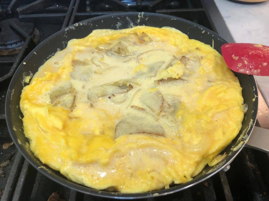 Egg frittata cooking in a pan