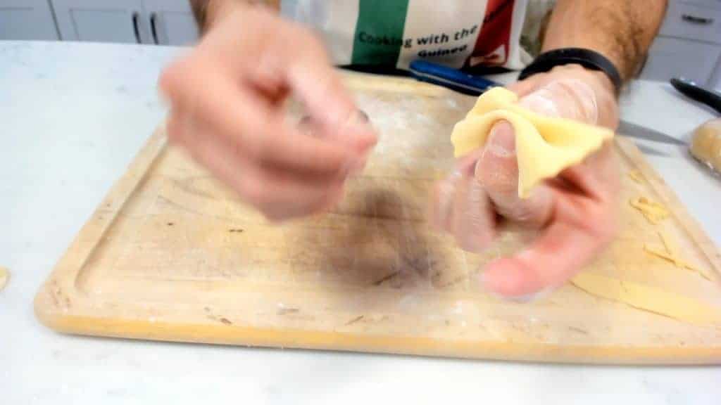 Pinching homemade farfalle