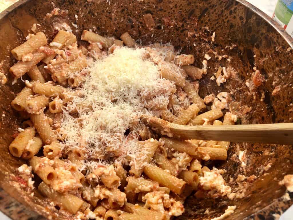 Parmesan cheese added to rigatoni