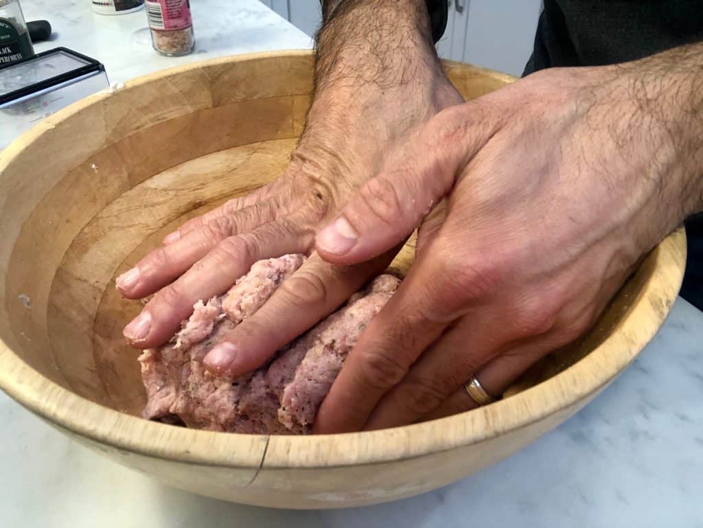 Mixing meat with hands