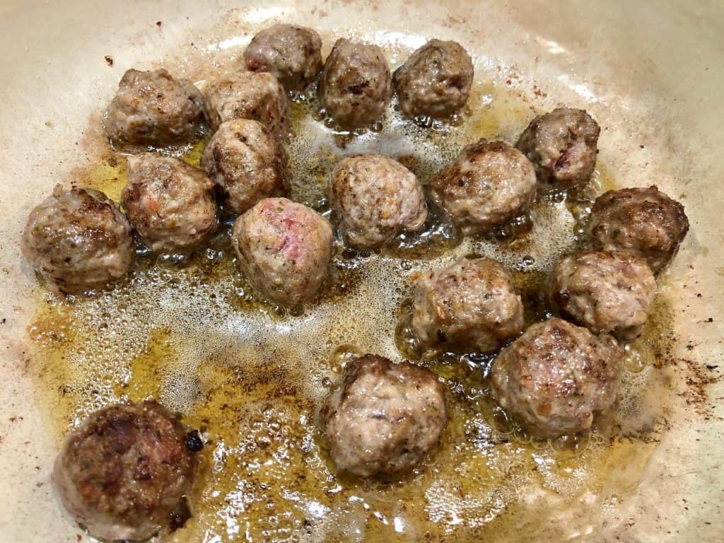 Meatballs frying in a pot