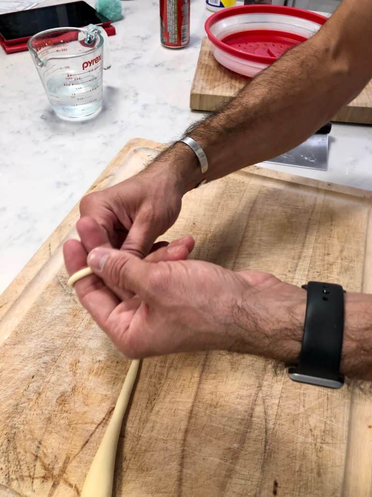wrapping pasta dough around fingers