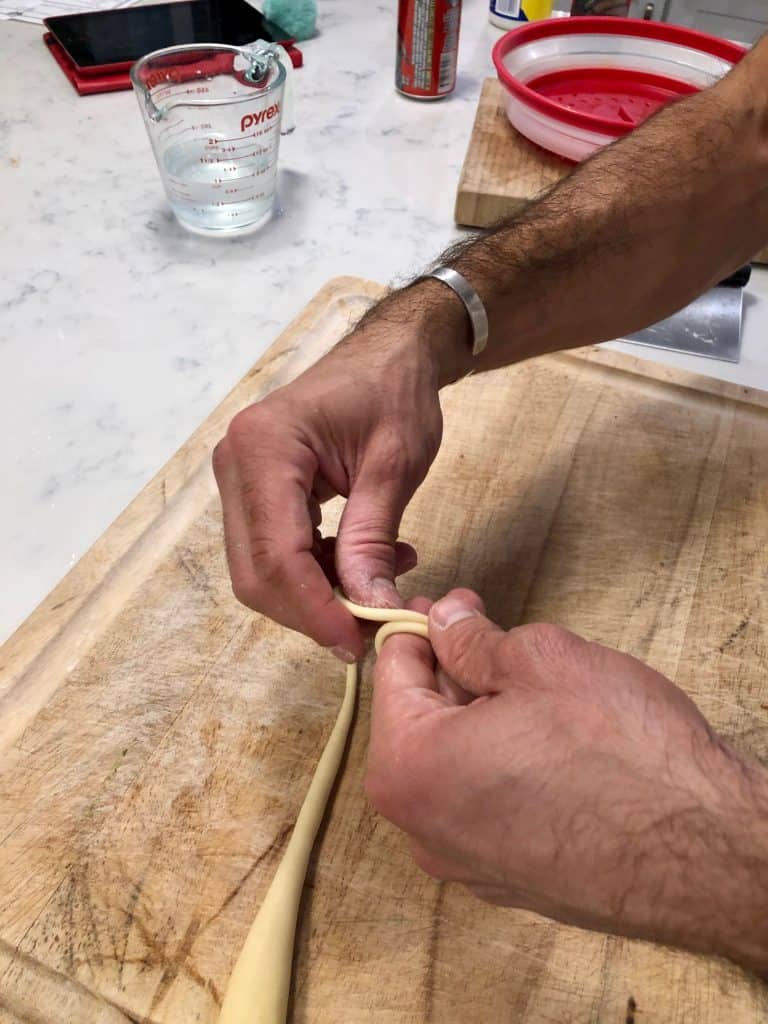 wrapping pasta dough around fingers