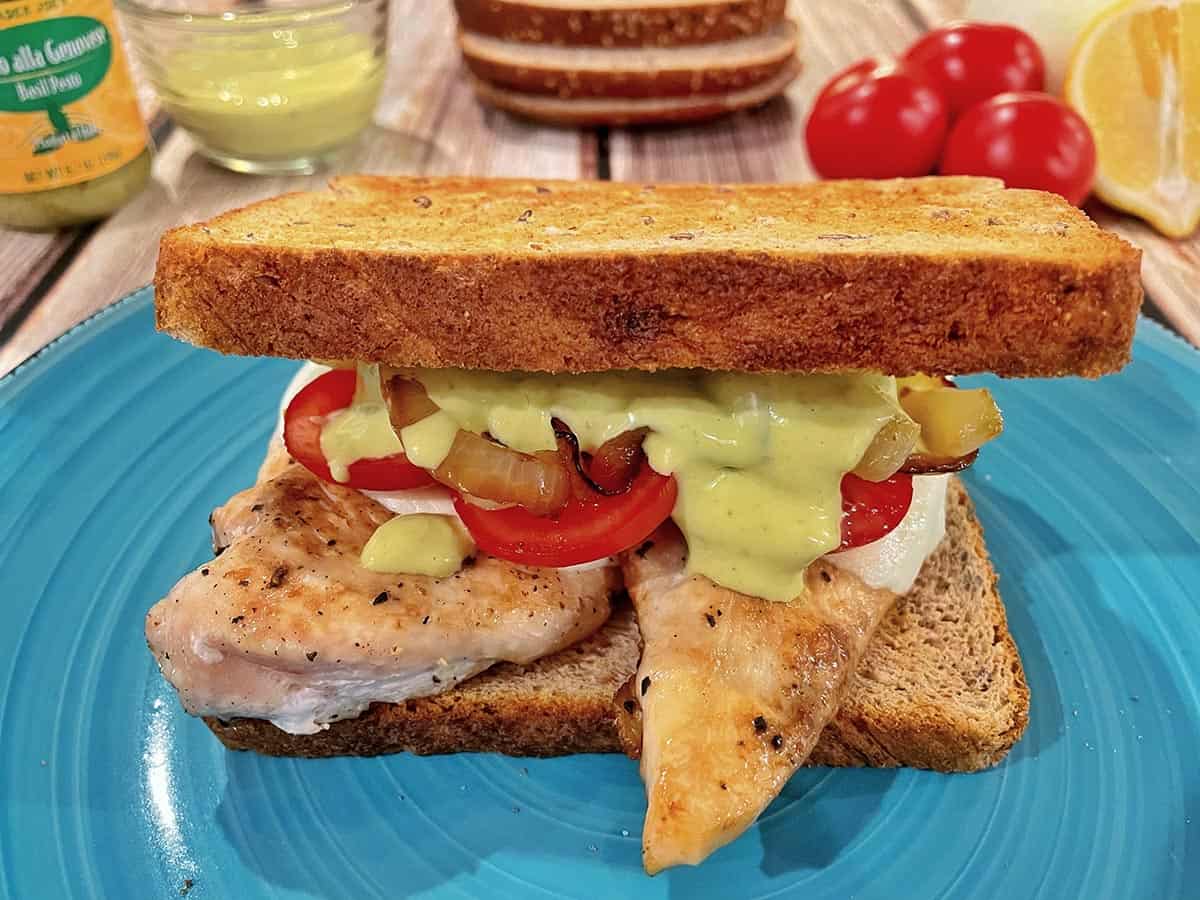 Chicken and pesto sandwich on a plate.
